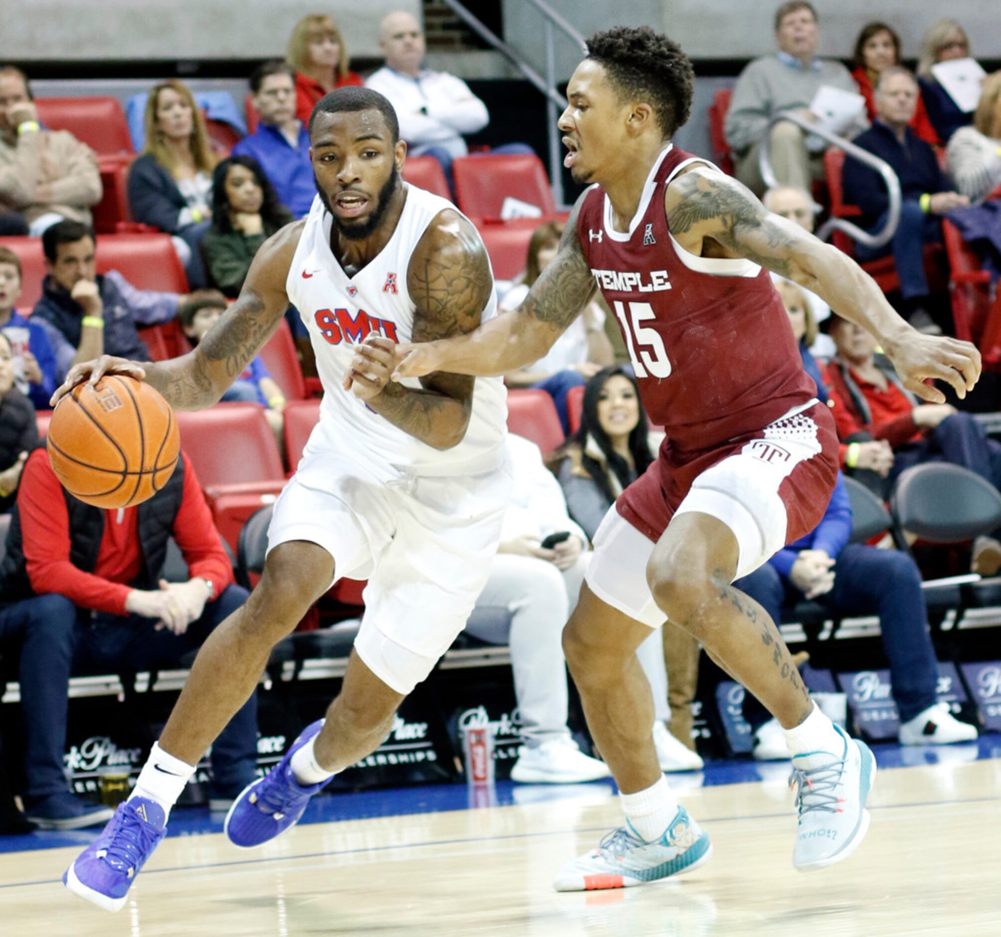 SMU guard Tyson Jolly (0) drives hard to the basket as he is defended by Temple guard Nate...