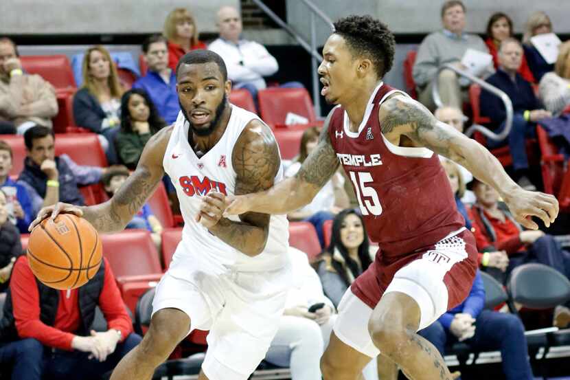 SMU guard Tyson Jolly (0) drives hard to the basket as he is defended by Temple guard Nate...