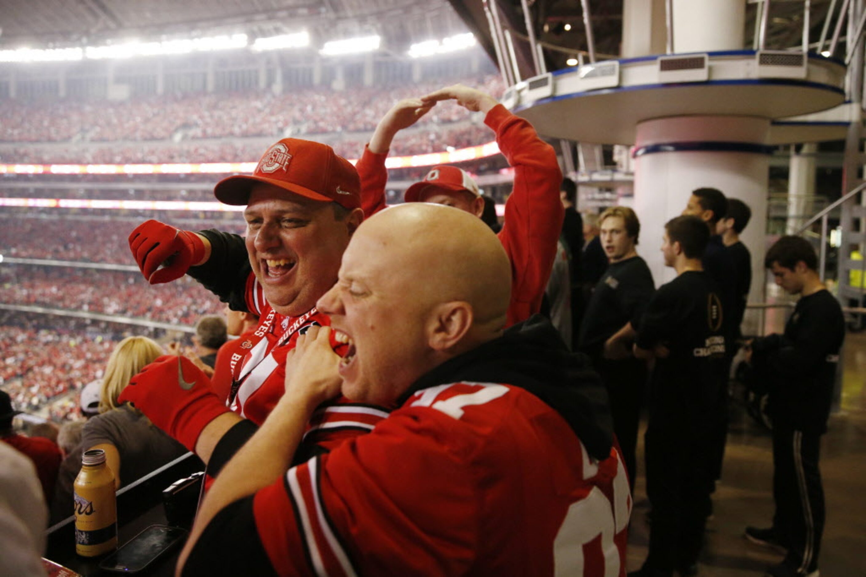 Ohio State Buckeyes fan Randy Urban (left) celebrates with his brother, Andy Urban, both of...