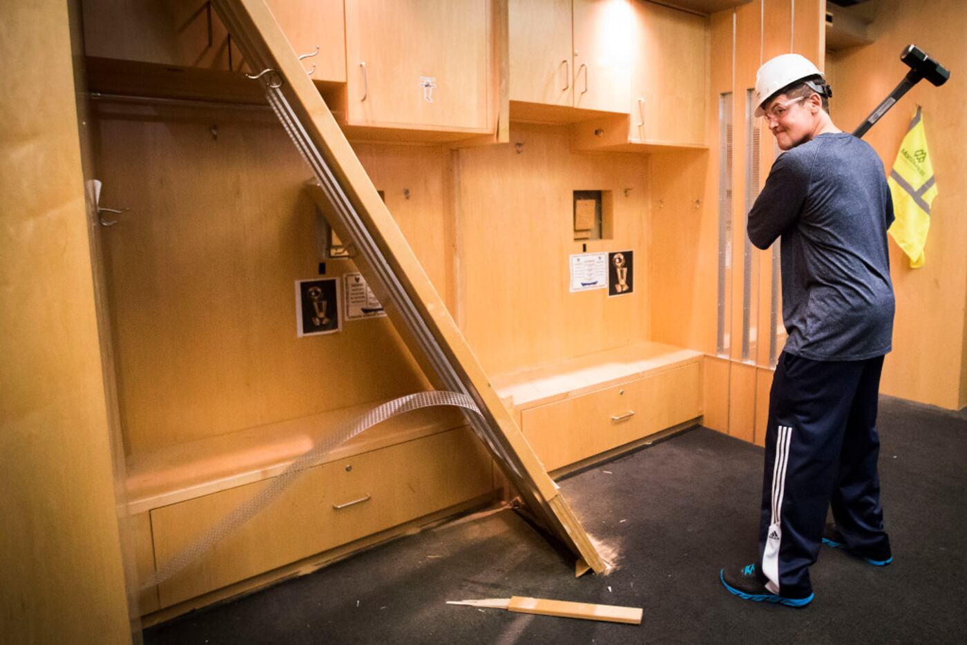 Dallas Mavericks owner Mark Cuban poses with a sledgehammer after he began the demolition...