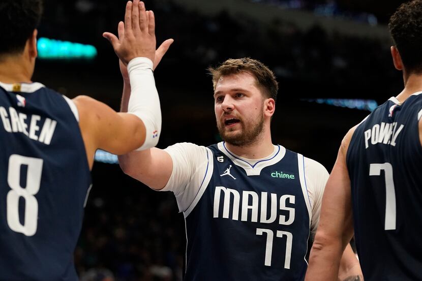 Dallas Mavericks guard Luka Doncic (77) and teammate Josh Green (8) celebrate during the...