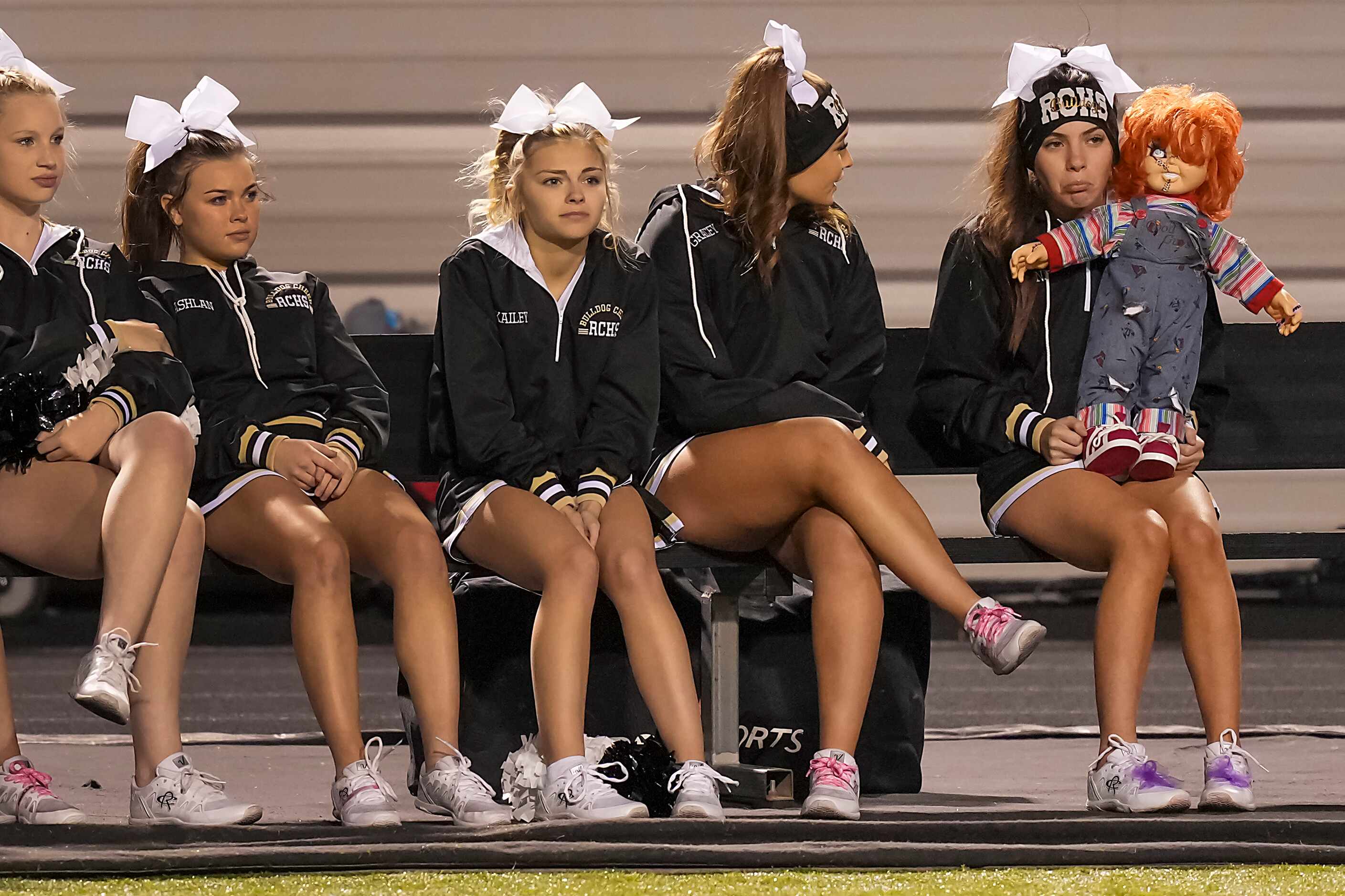 Royse City cheerleaders watch from the bench during senior day festivities before a District...