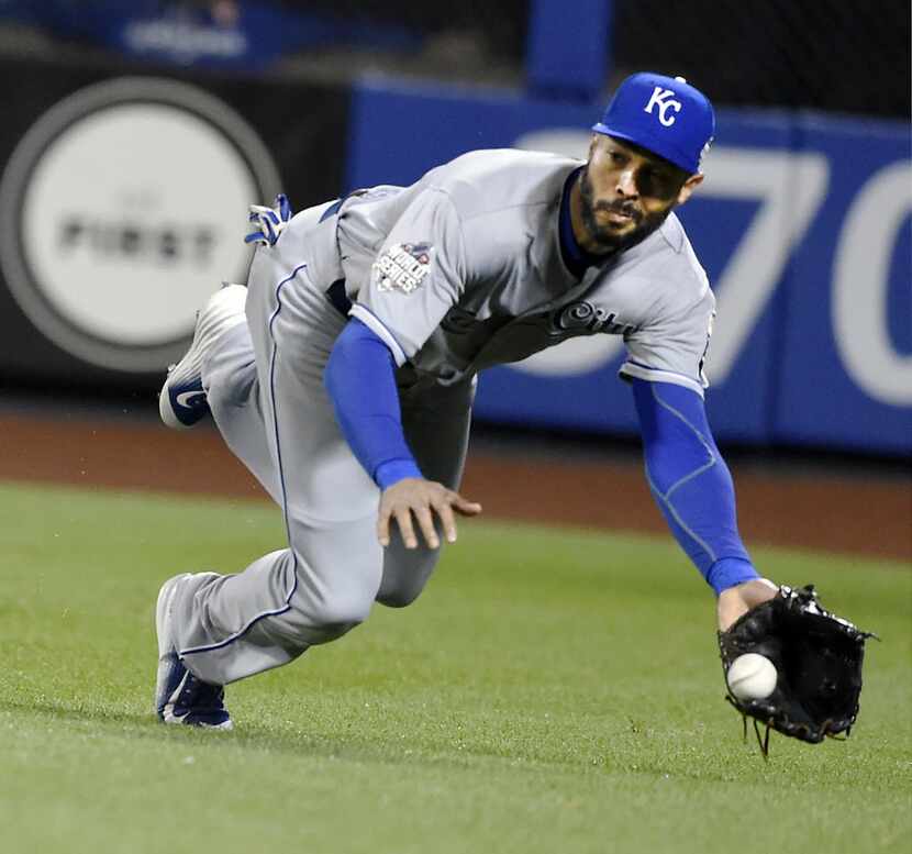 Kansas City Royals right fielder Alex Rios dives to make to catch a fly ball hit by the New...