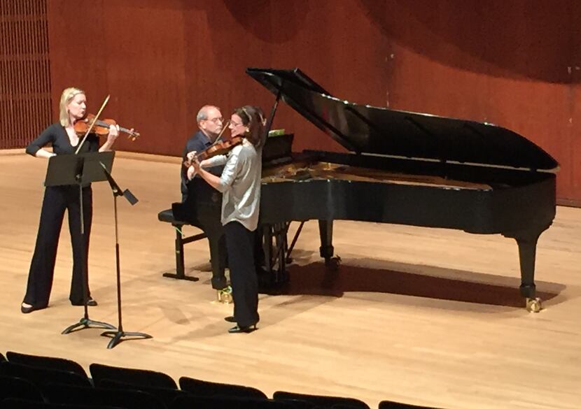 Violinists Angela Fuller Heyde (left) and Maria Schleuning and pianist Steven Harlos play...