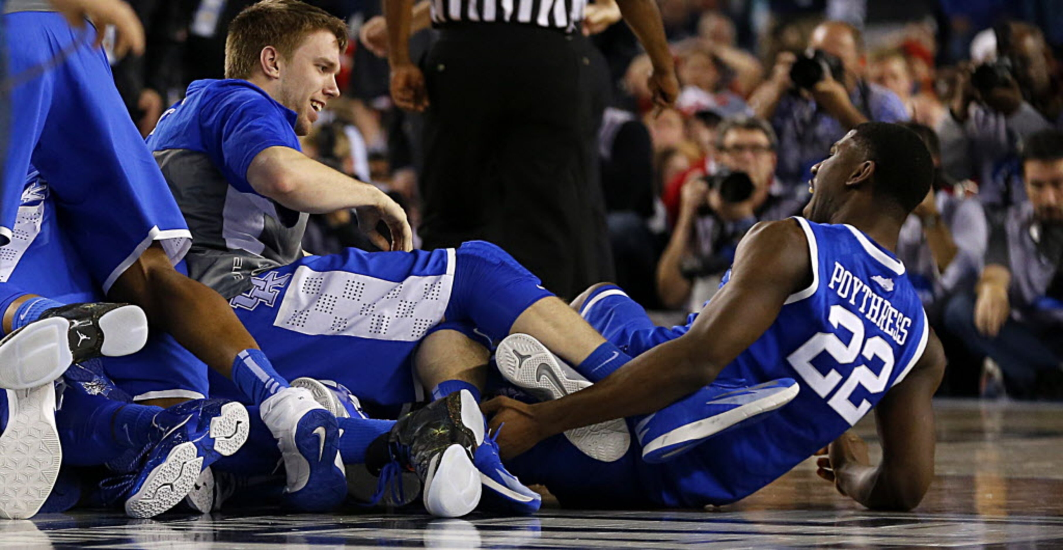 Kentucky Wildcats forward Alex Poythress (22) screams as his teammates crushed his legs in...