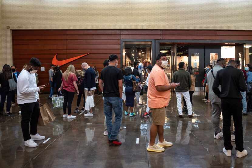 A long line of shoppers snaked in front of the Nike store during Black Friday at NorthPark...