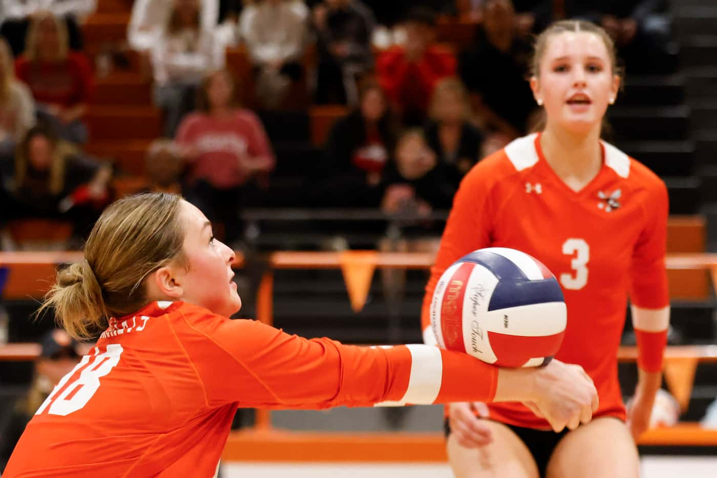 Rockwall high’s Janie Deapen (left) digs the ball as Harley Krause spikes the ball against...