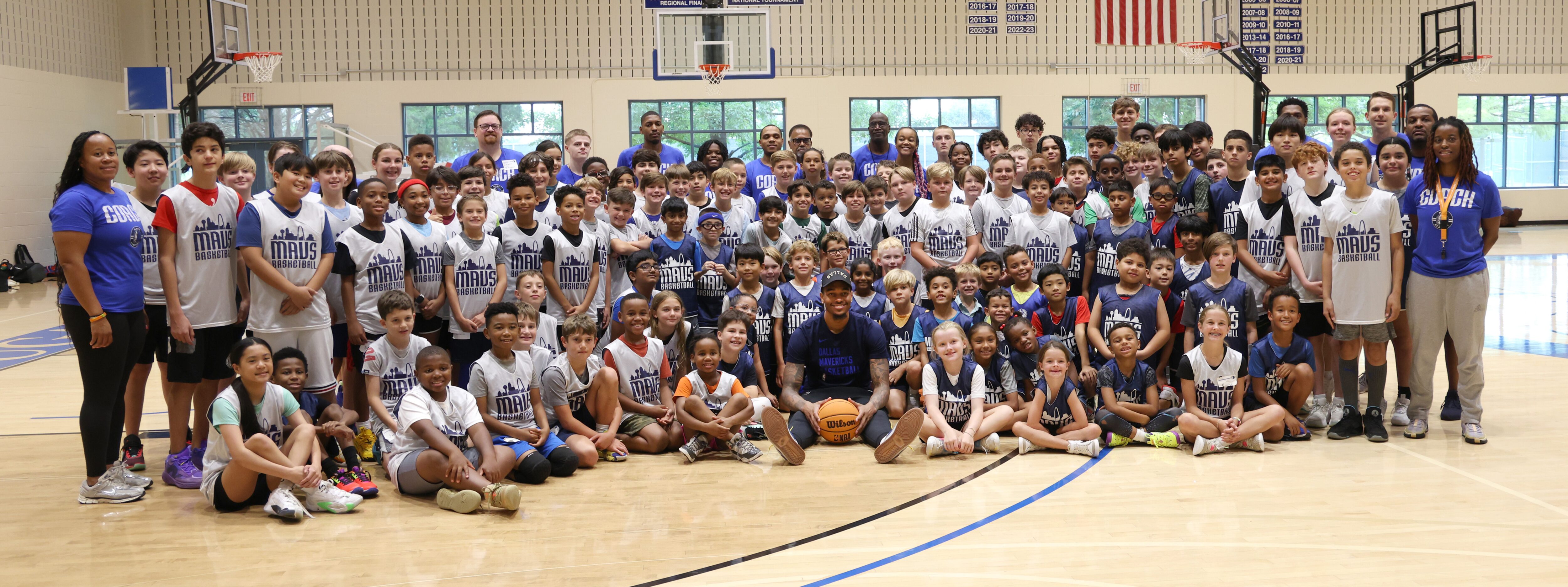 Dallas Mavericks forward and center PJ Washington, center, poses for a group photo with Hoop...