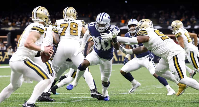 Dallas Cowboys defensive end Demarcus Lawrence (90) tries to get to New Orleans Saints...