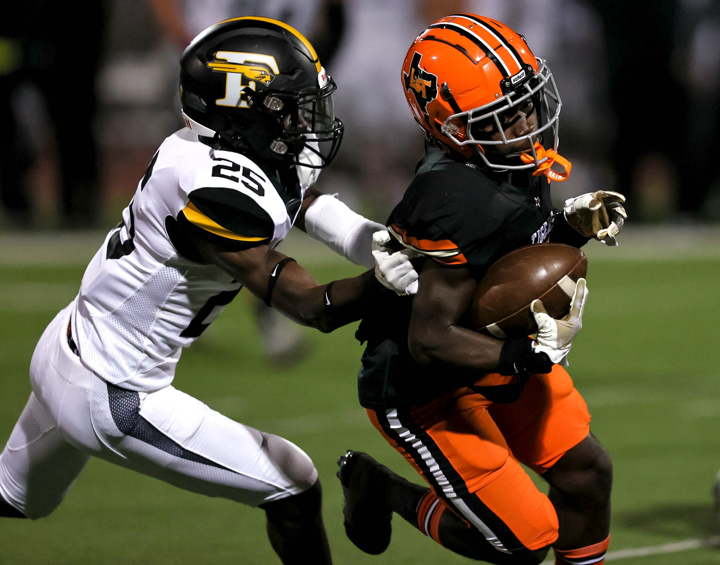 Lancaster wide receiver Maurice Sherrad (right) comes up with a reception and tries to get...