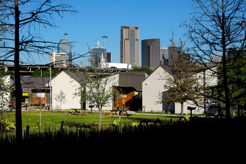 The Dallas skyline rises above the Cottages at Hickory Crossing, which are located on the...