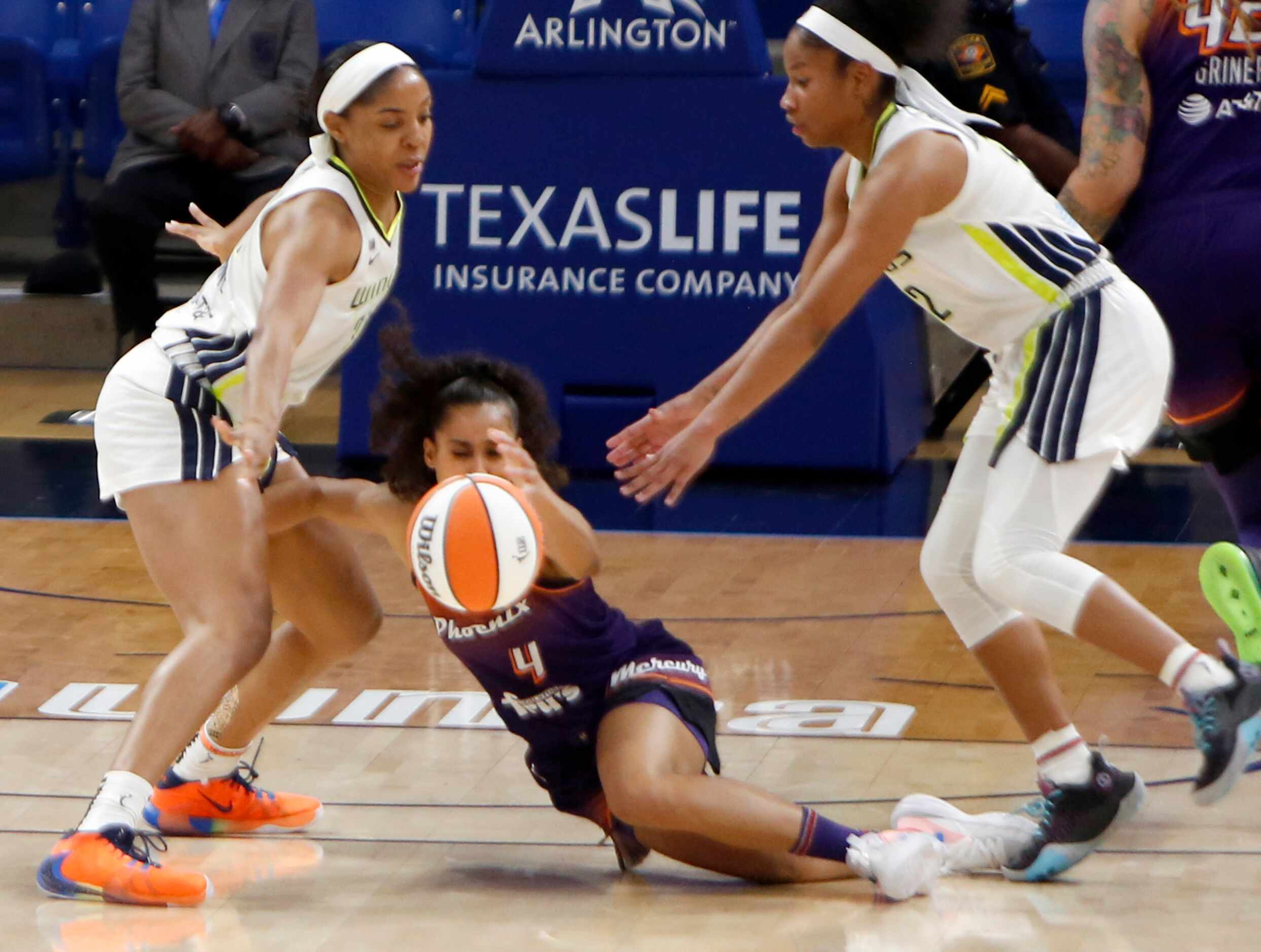 Phoenix guard Shylar Diggins-Smith (4) loses the ball after being tripped by a teammate as...