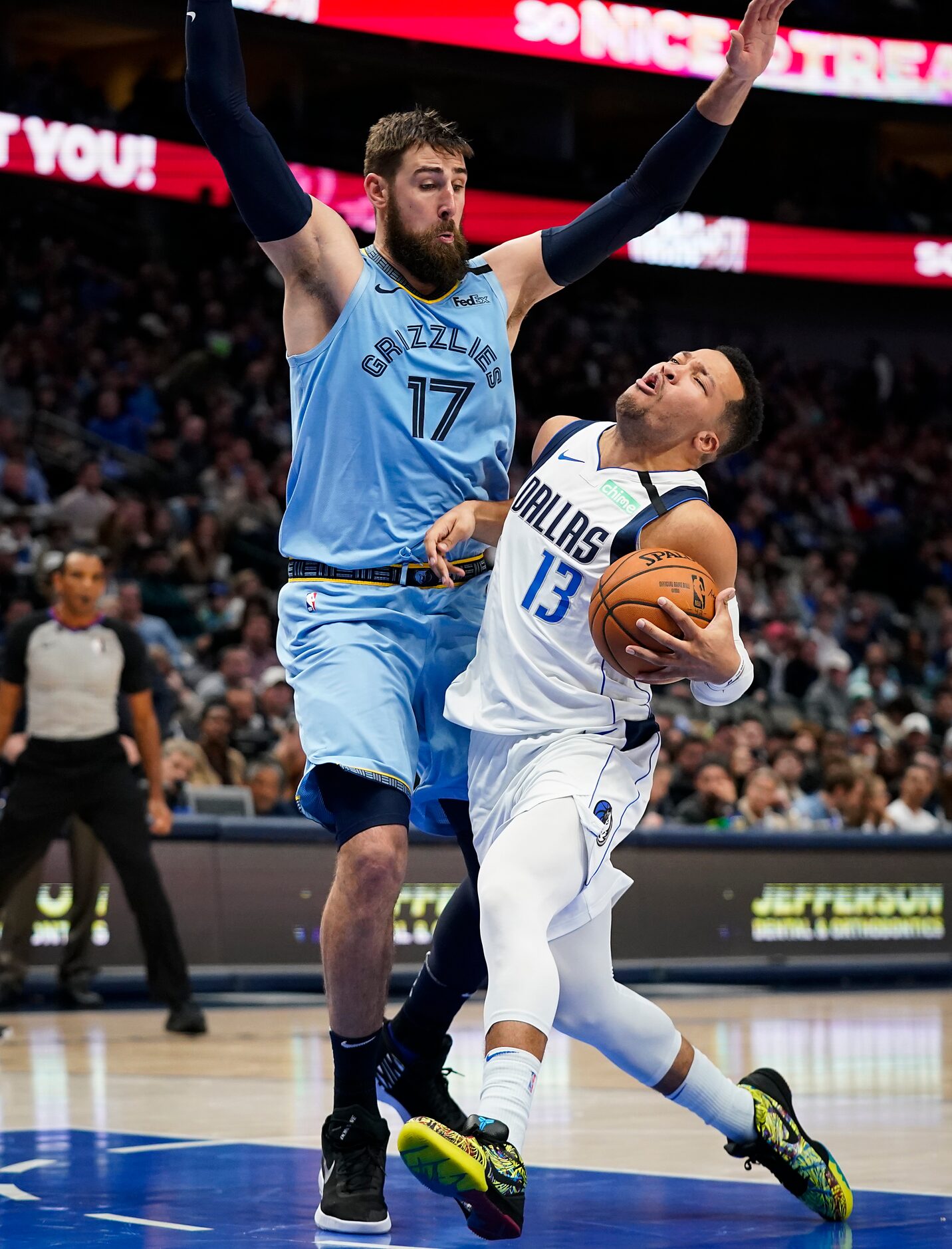 Dallas Mavericks guard Jalen Brunson (13) collides with Memphis Grizzlies center Jonas...