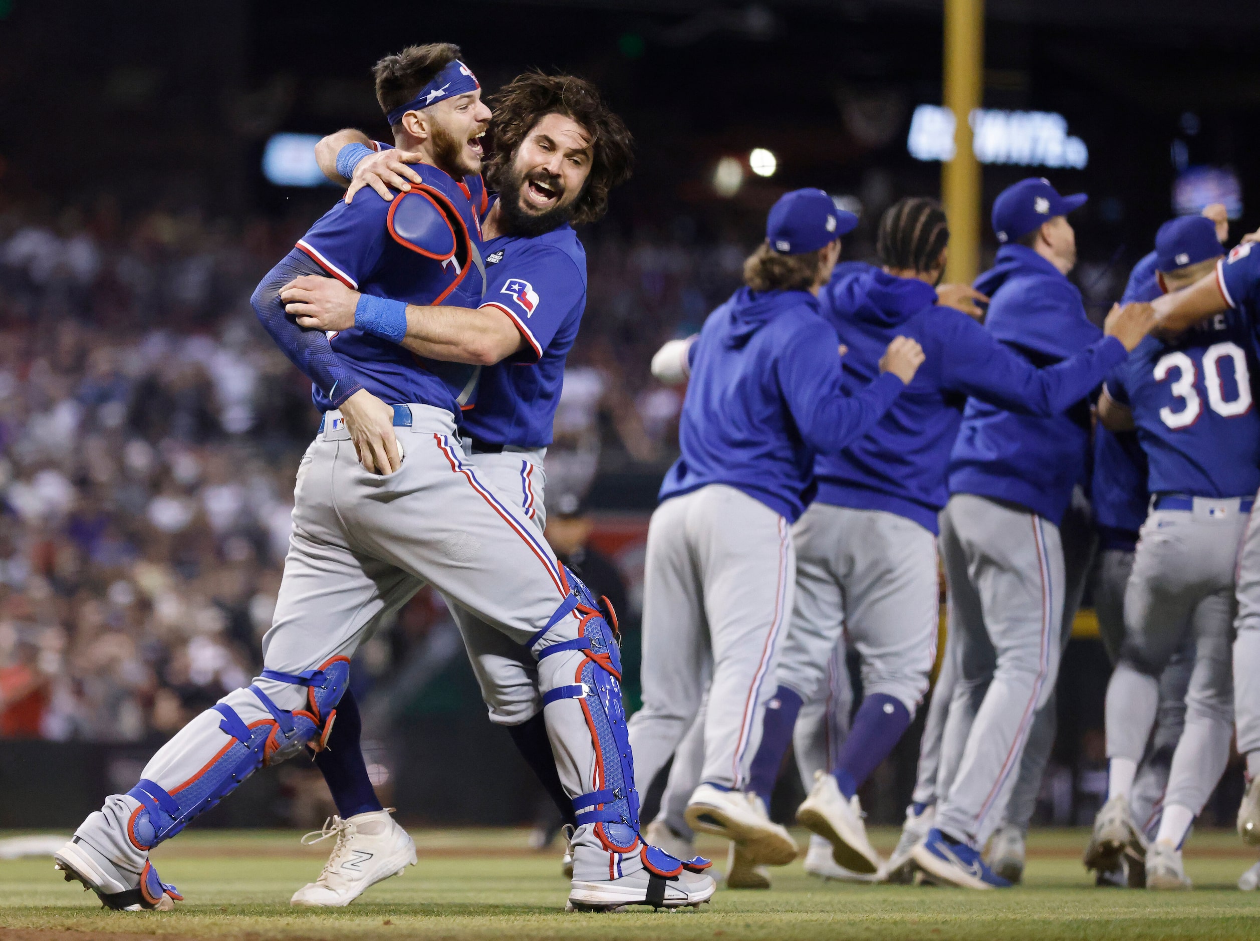 Texas Rangers catcher Jonah Heim (left) and Austin Hedges celebrate after Heim ran to find...