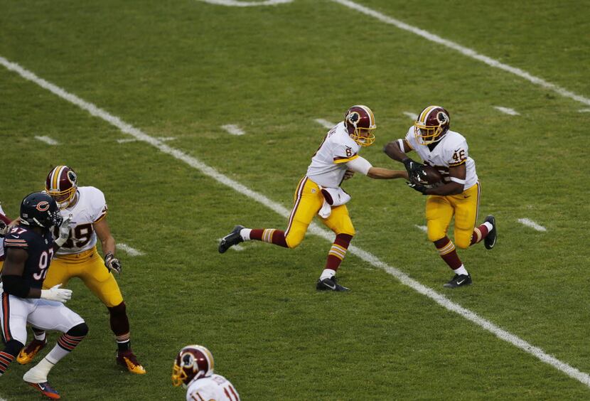 Washington Redskins quarterback Kirk Cousins (8) hands off to running back Alfred Morris...