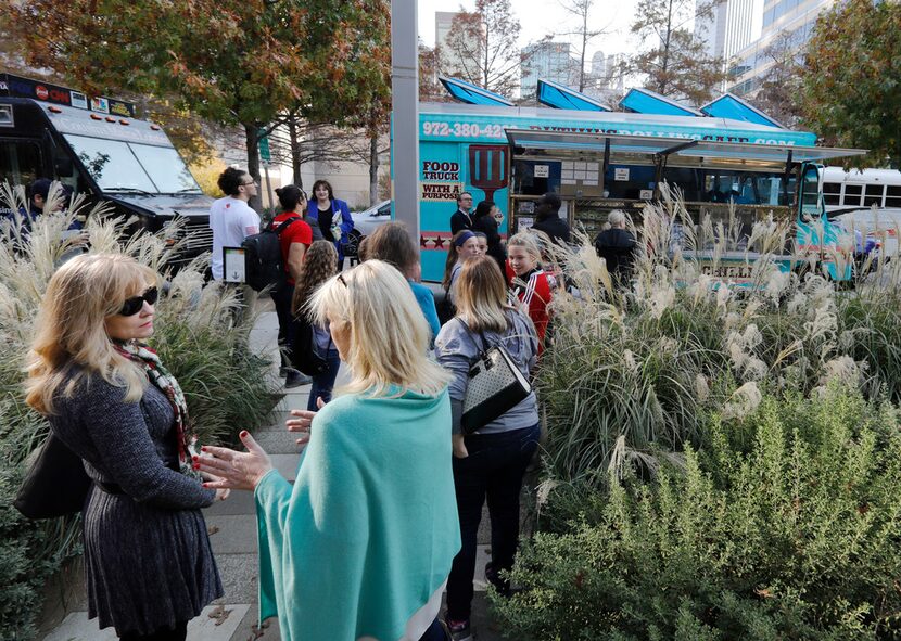 People wait in line to order from Ruthie's Rolling Cafe food truck at Klyde Warren Park.