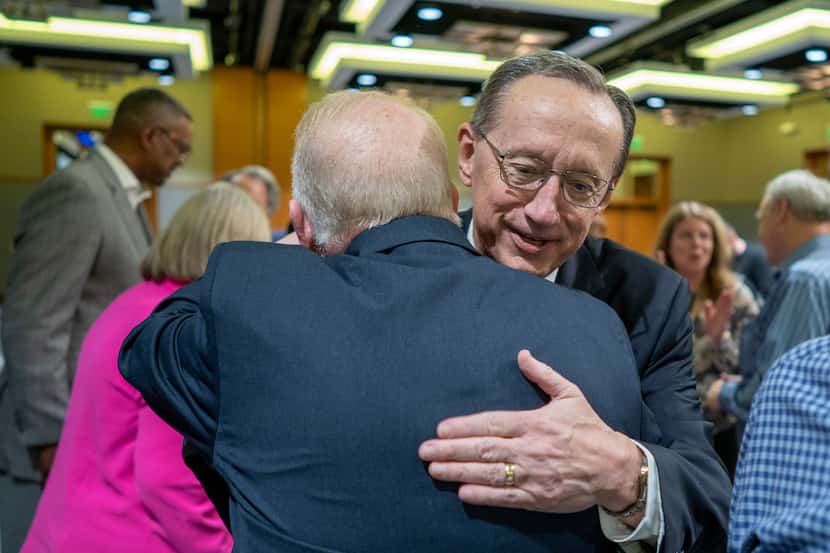 Jeff Iorg, right, hugs presidential search team chair Neal Hughes, Thursday, March 21, 2024,...