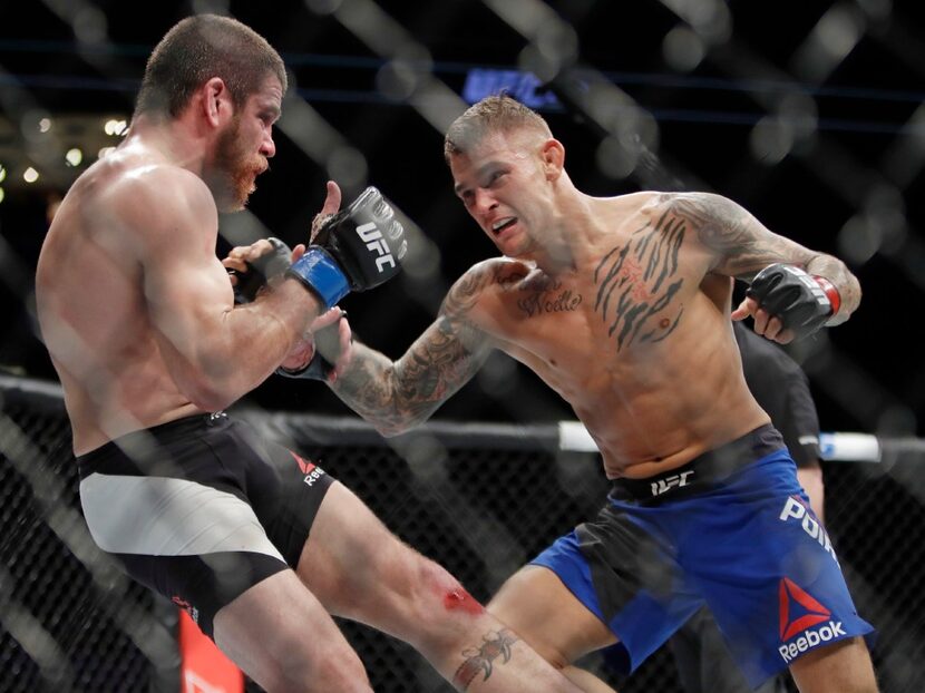 Dustin Poirier, right, fights Jim Miller during a lightweight mixed martial arts bout at UFC...