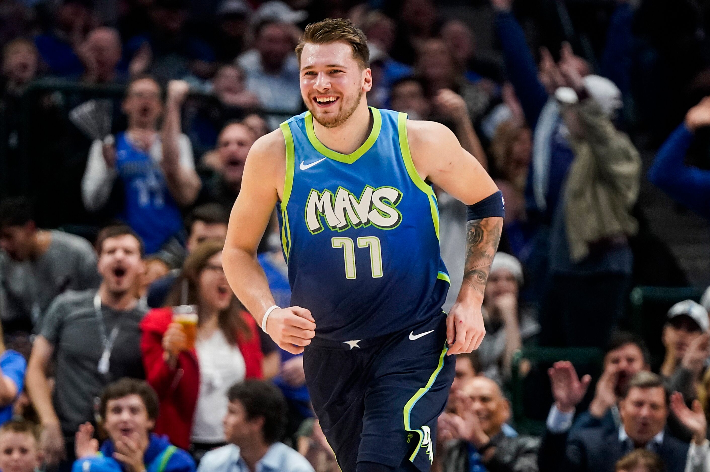 Dallas Mavericks guard Luka Doncic celebrates after throwing down a dunk during the first...