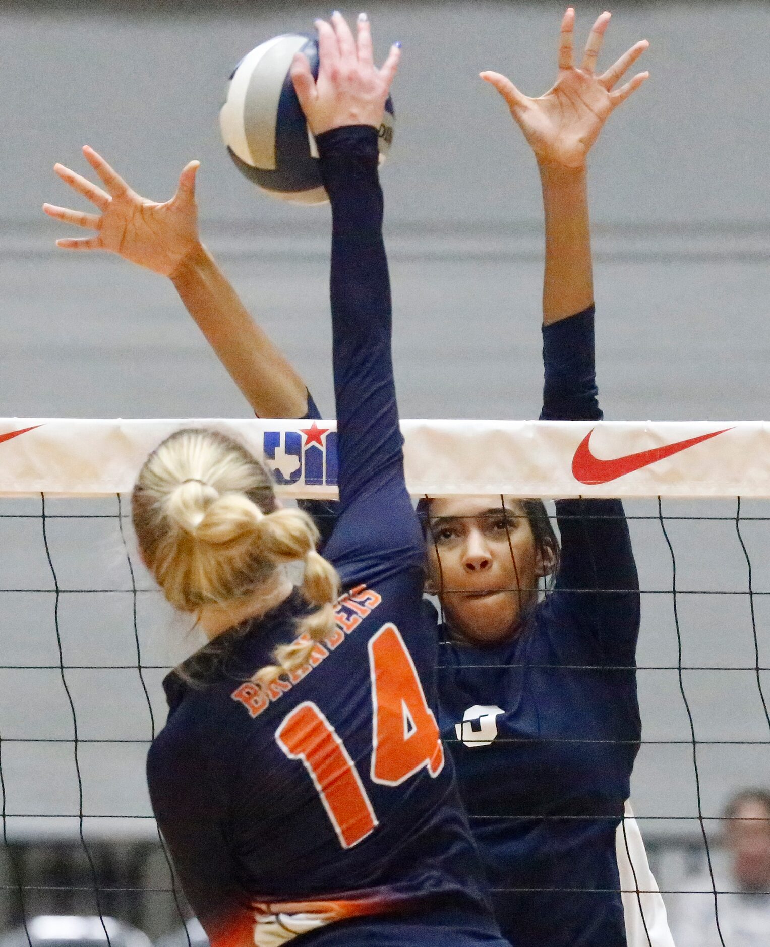 Northside Bandeis outside hitter Emma Halstead (14) makes a hit as Keller middle Leah Ford...