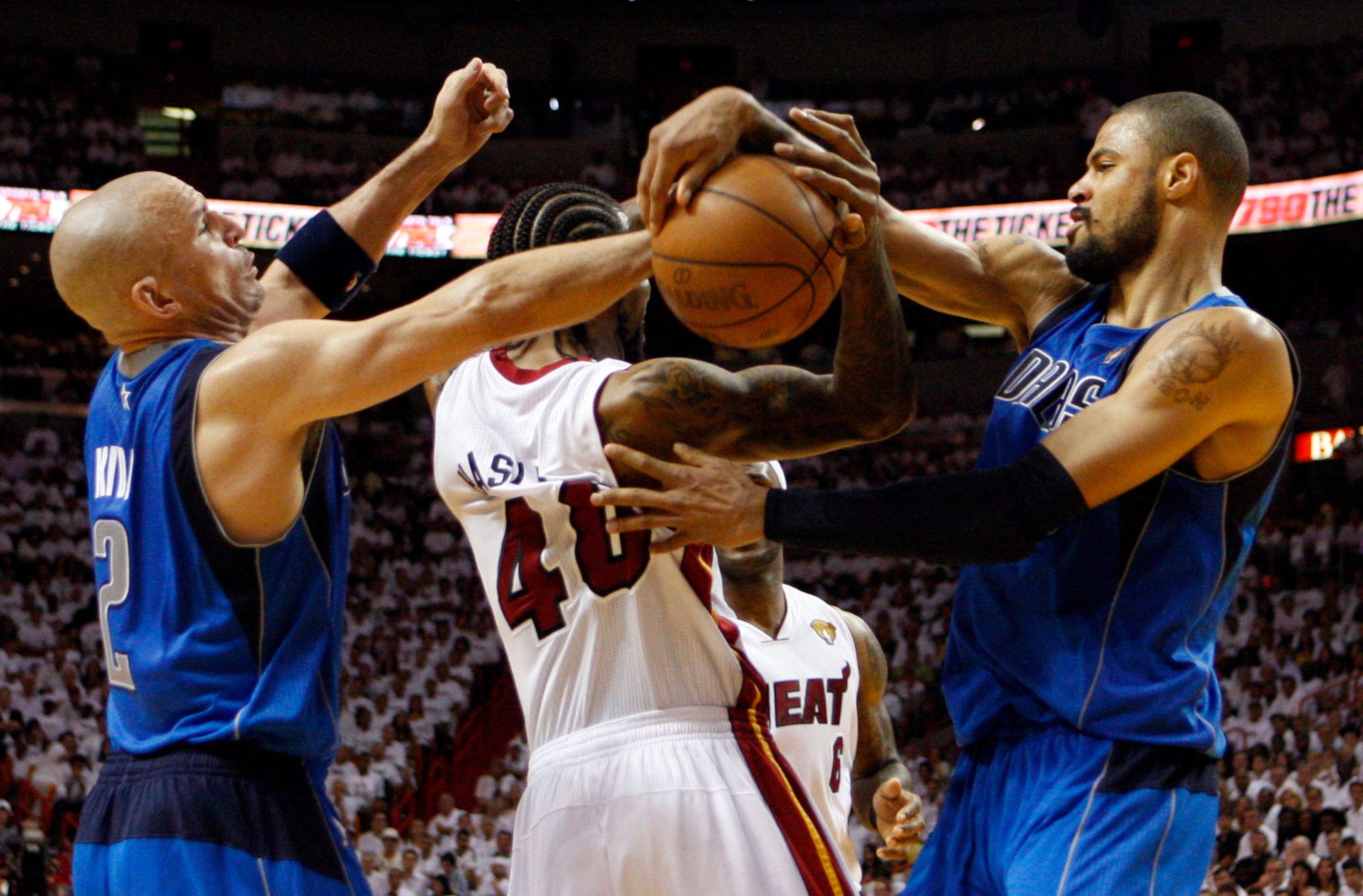 Dallas Mavericks point guard Jason Kidd (2) and Dallas Mavericks center Tyson Chandler (6)...