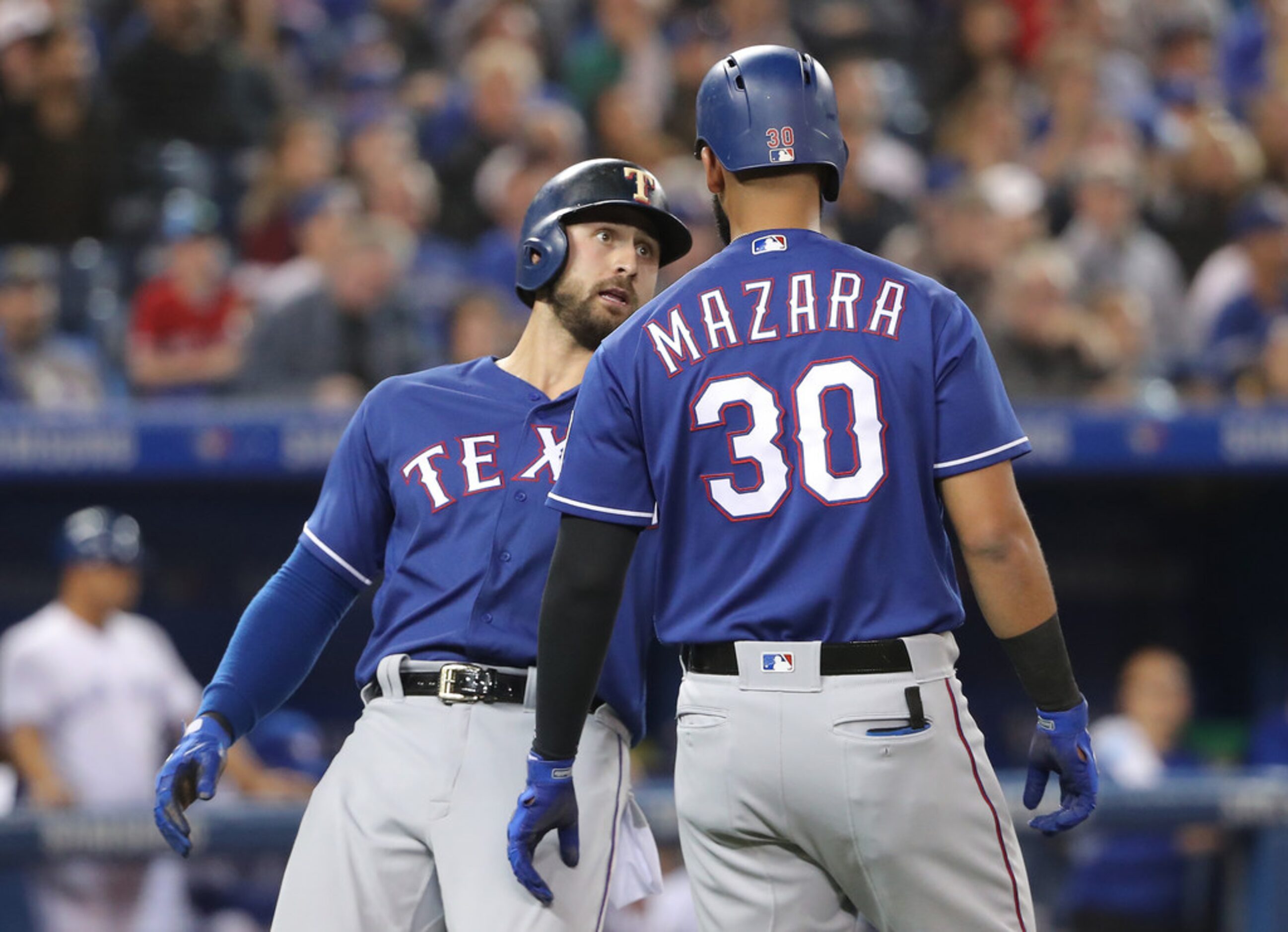 TORONTO, ON - APRIL 27: Joey Gallo #13 of the Texas Rangers celebrates with Nomar Mazara #30...