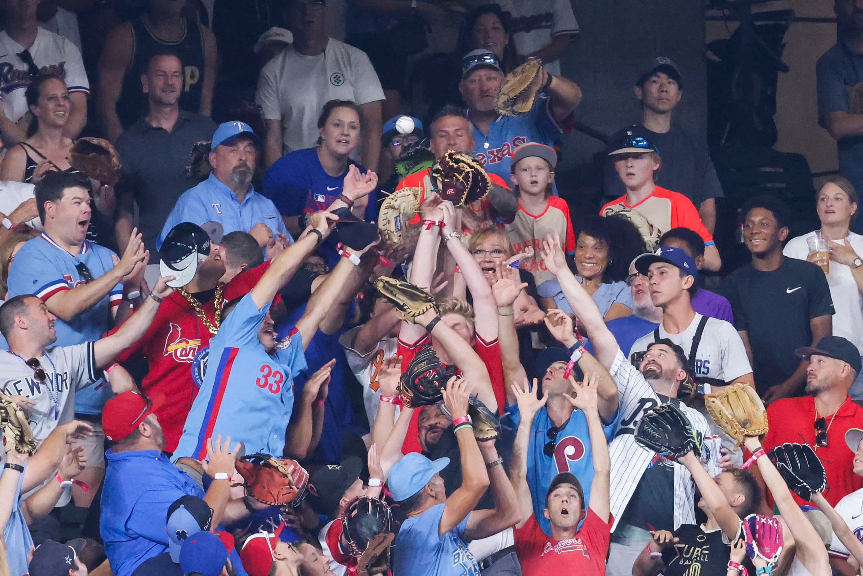 Crowd catch a homerun ball hit by Alec Bohm, of the Philadelphia Phillies during MLB...