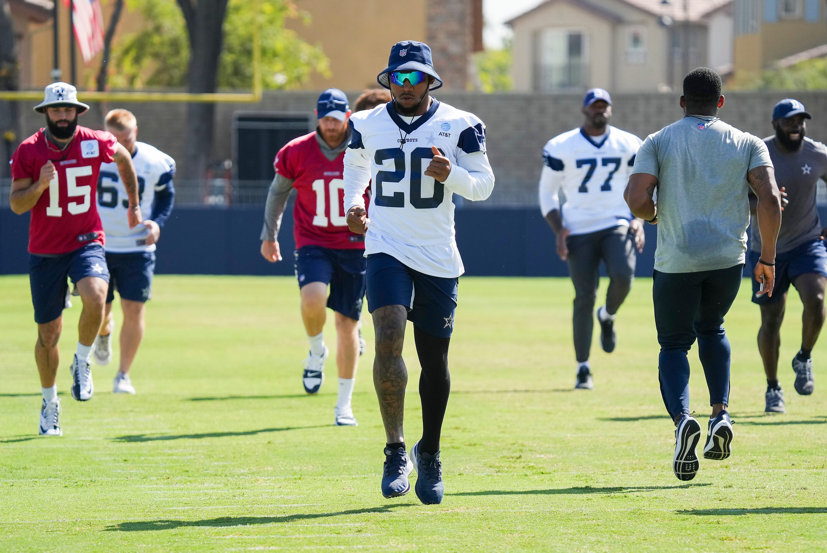 Dallas Cowboys running back Tony Pollard (20) runs with teammates during a training camp...