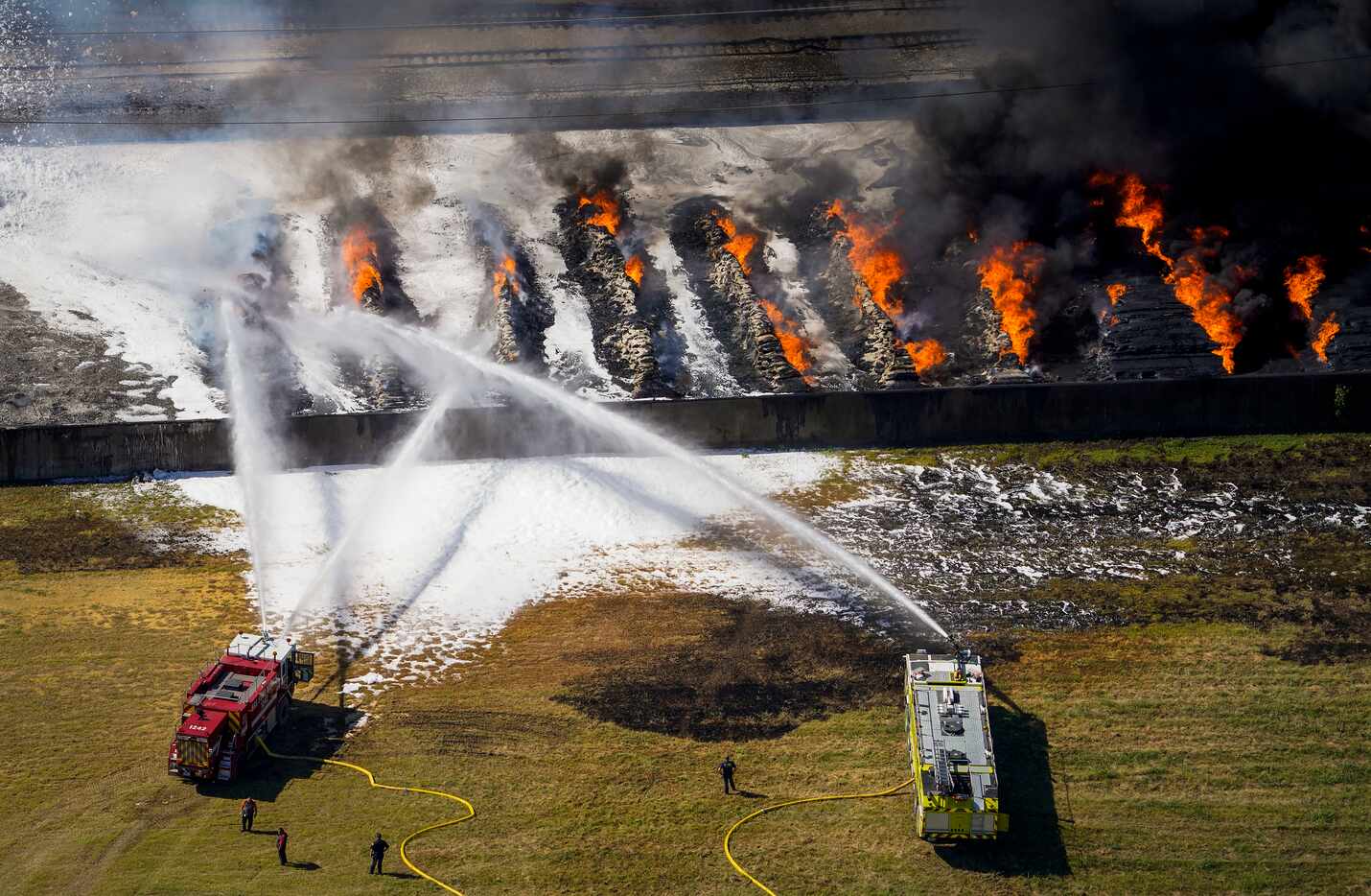 Aerial view of fire crews working at the site of a massive blaze in an industrial area on...