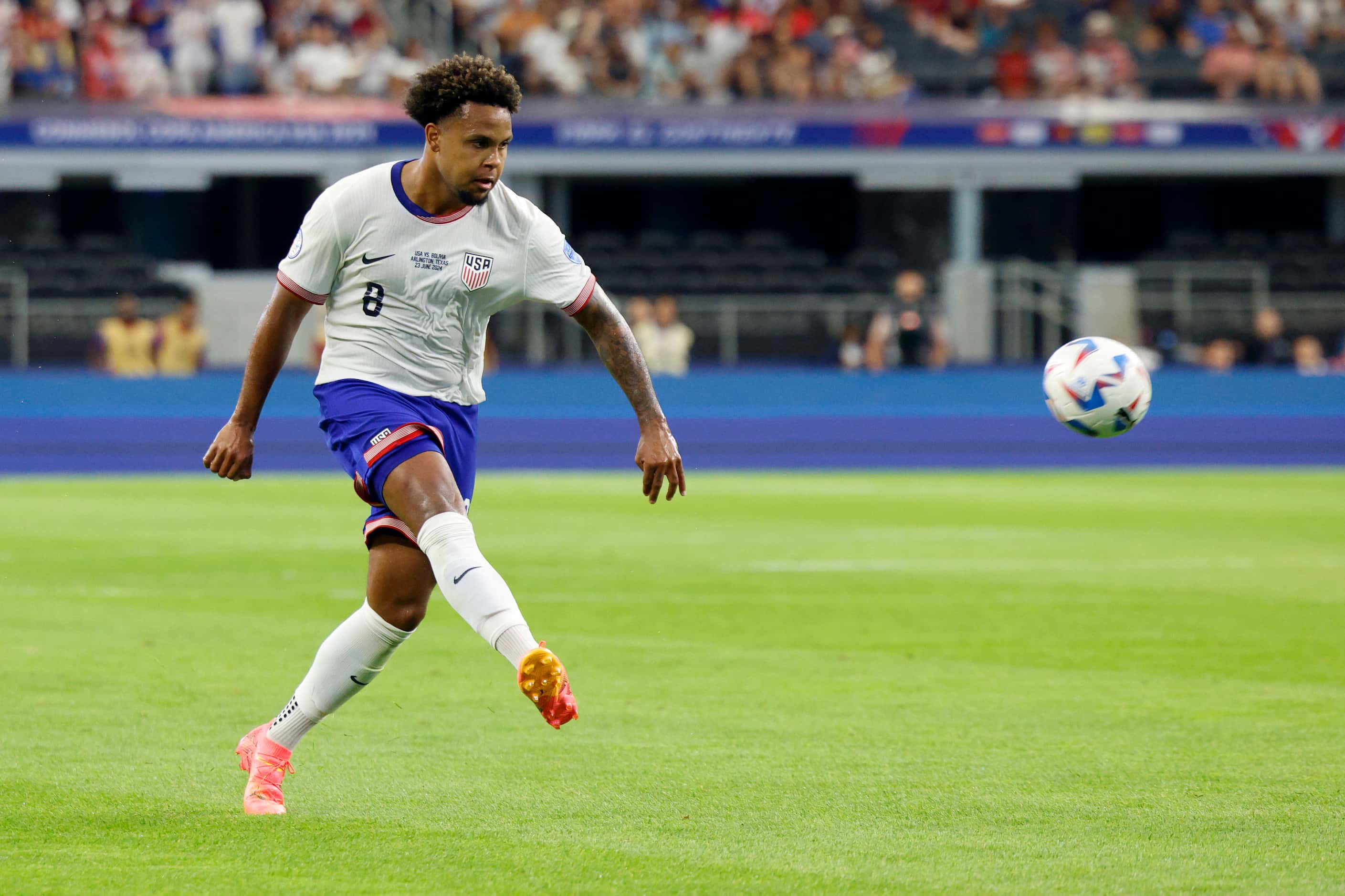 United States midfielder Weston McKennie (8) crosses the ball towards goal during the first...