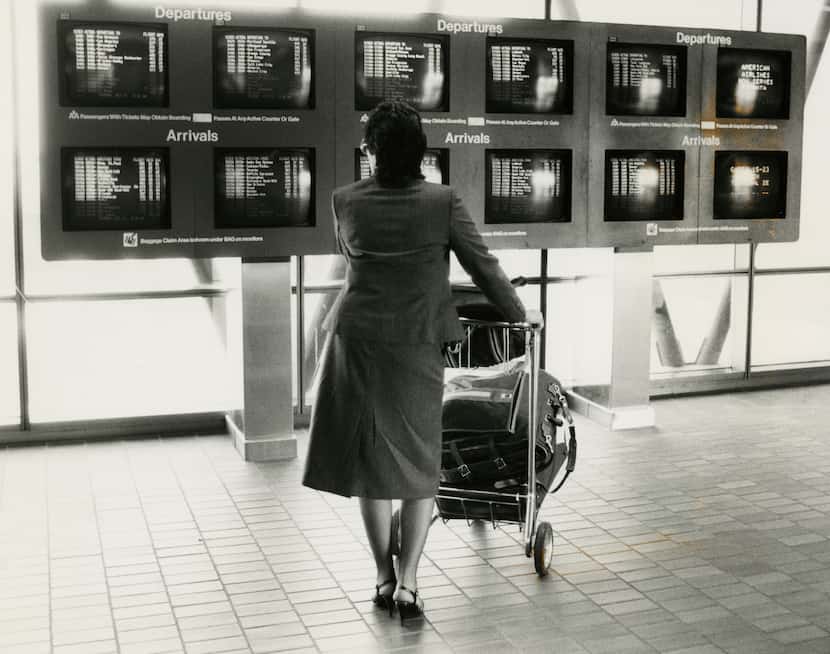 A passenger checks arrivals and departures at DFW International Airport in 1981.