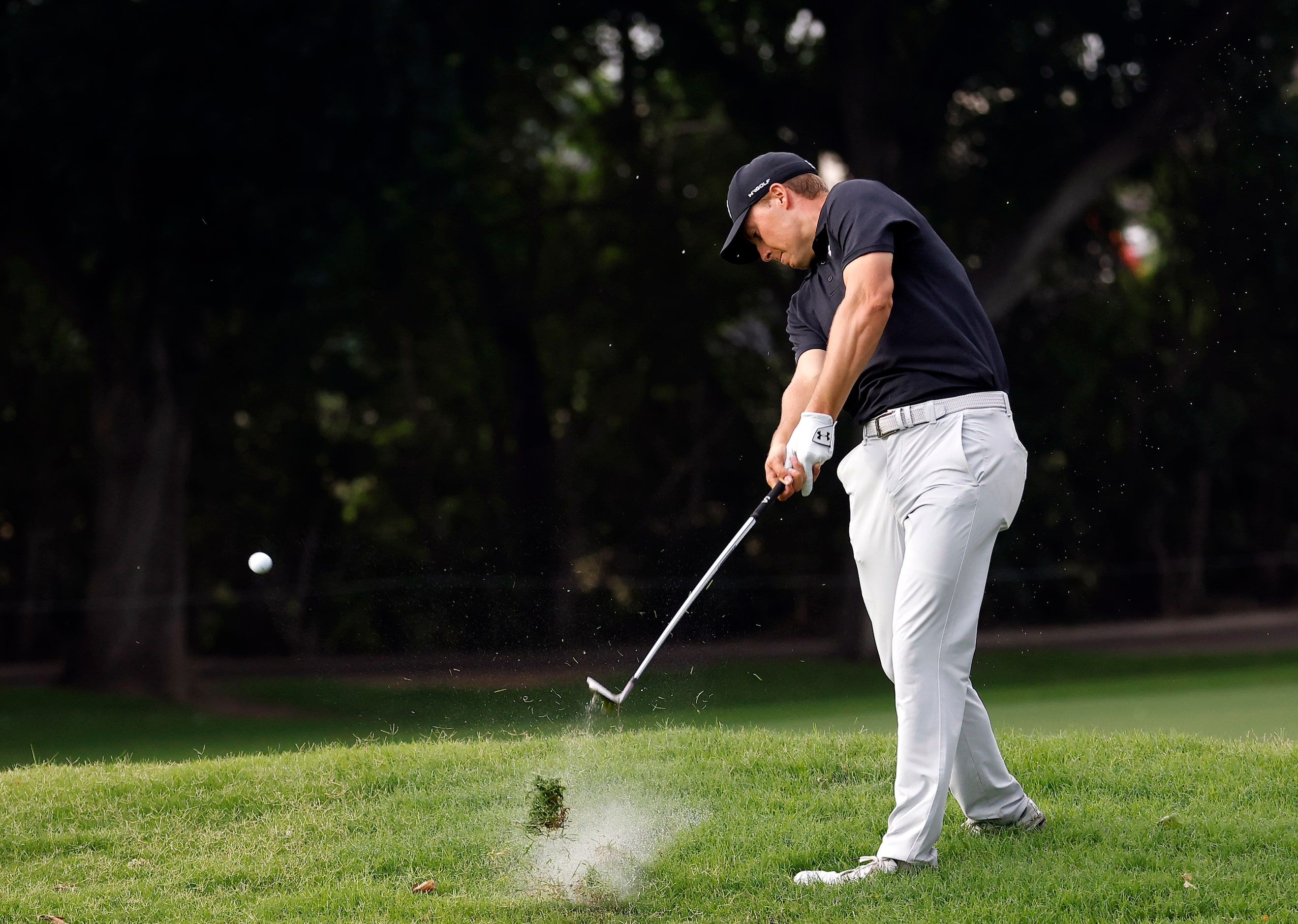 Professional golfer Jordan Spieth strikes his approach shot on No. 12 during round two of...