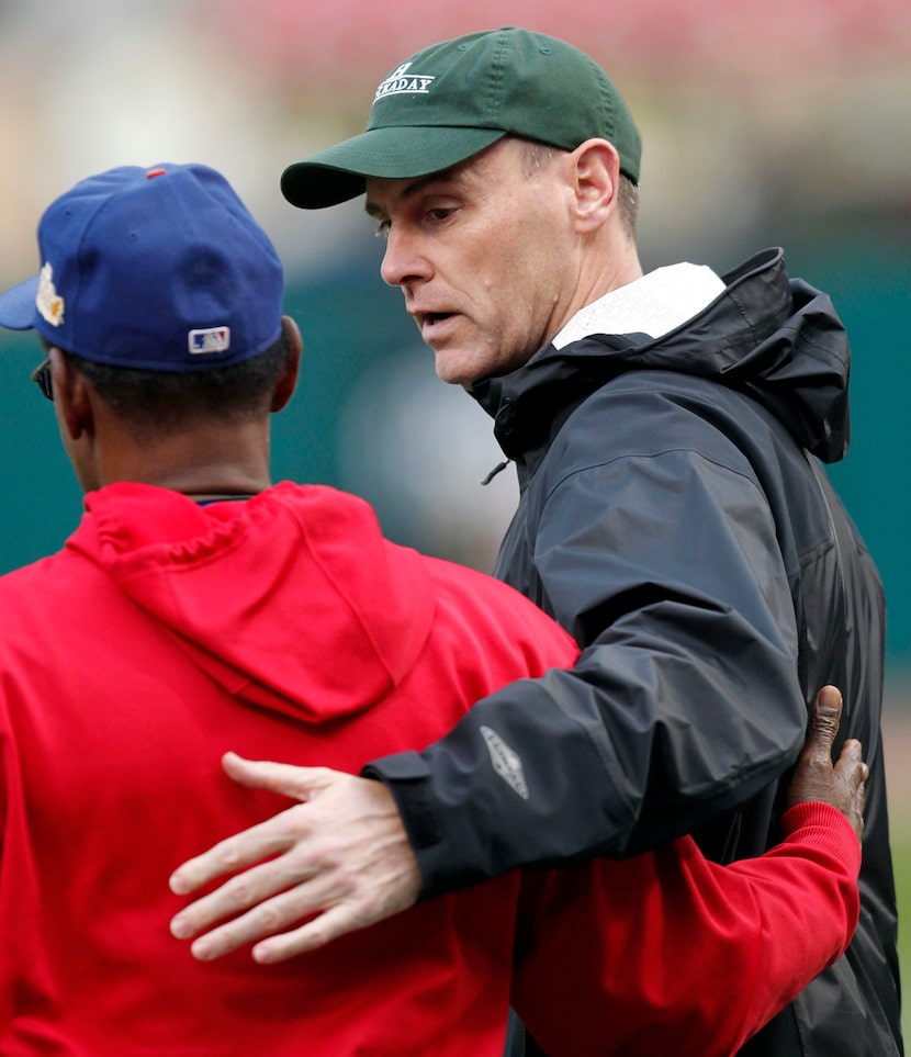 Dallas Mavericks head coach Rick Carlisle talks with Texas Rangers manager Ron Washington...