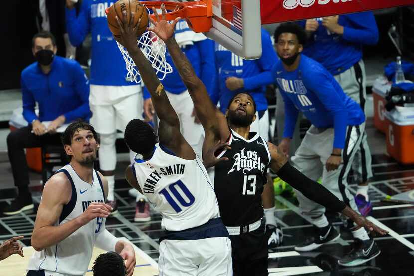 Dallas Mavericks forward Dorian Finney-Smith (10) dunks the ball past LA Clippers guard Paul...