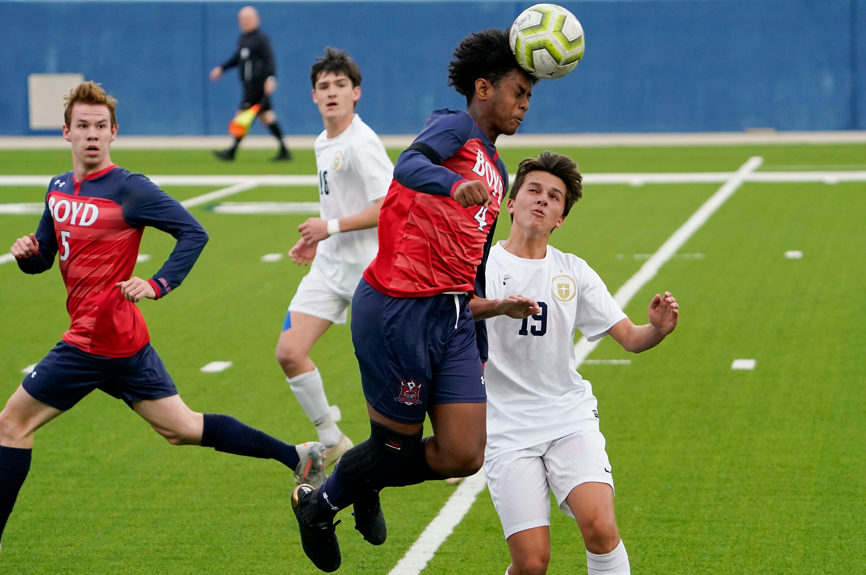 McKinney Boyd forward Aimon Ibssa (4) wins a header against Jesuit midfielder Andrew...