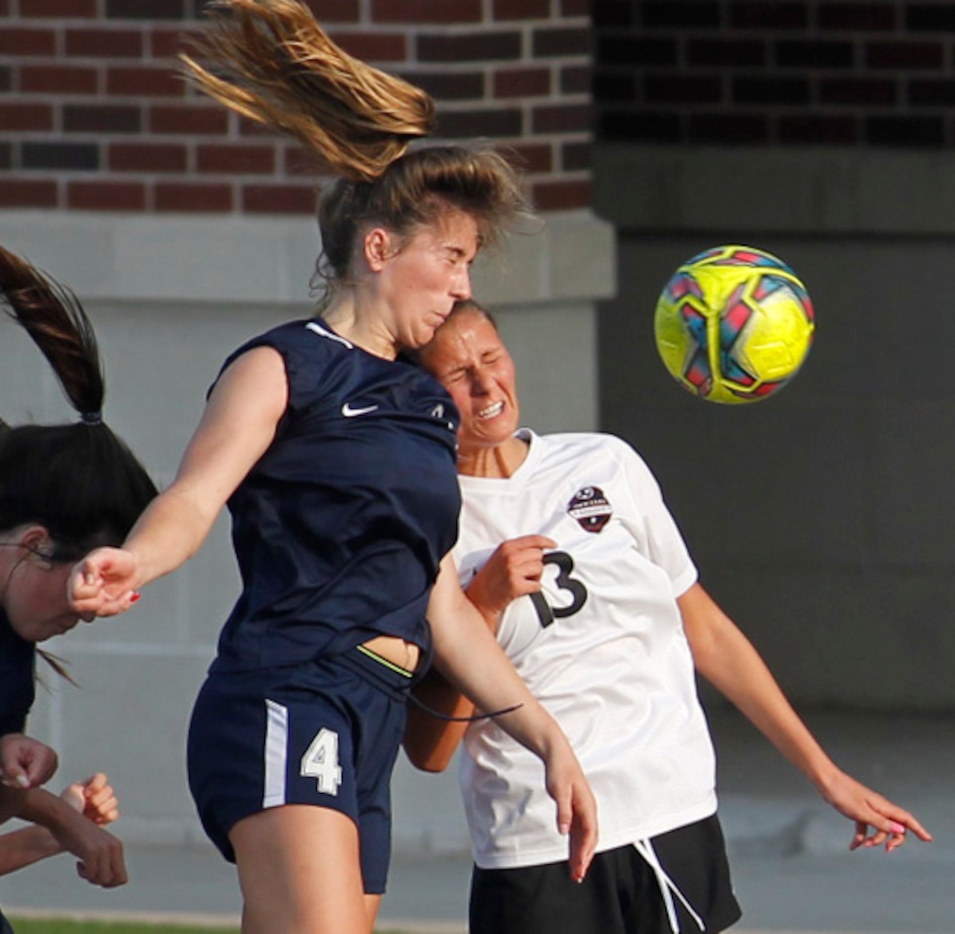 Flower Mound's Marianne Baltmanis (4), heads the ball past Flower Mound Marcus defender...