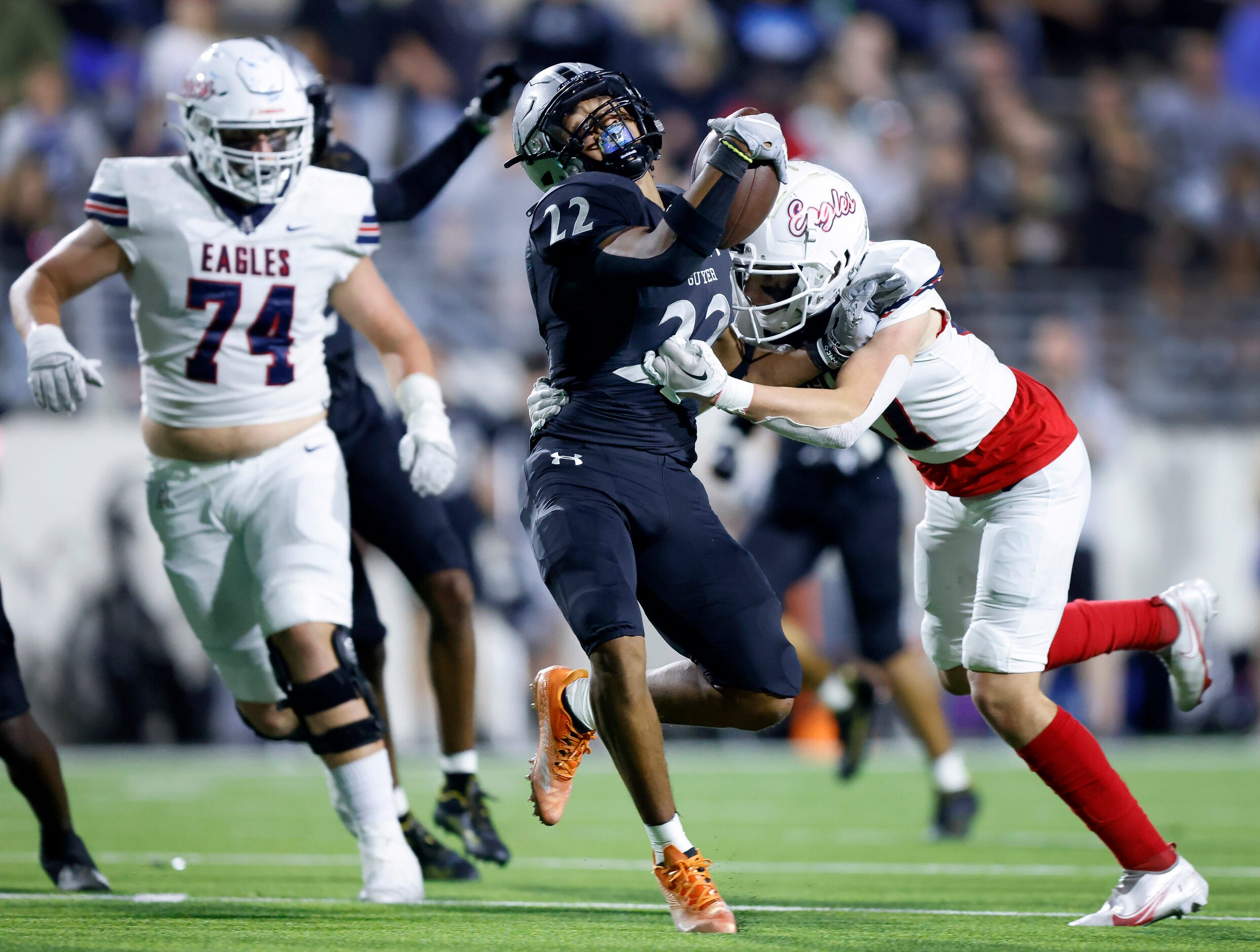 Denton Guyer punt returner Peyton Bowen (22) broke several tackles, including this one by...