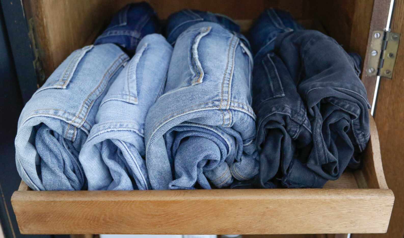 Caroline Rector's rolled jeans are packed neatly in a cubby and easy to see.