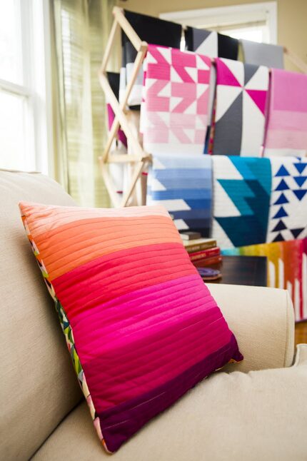 Finished quilts by Kristi Schroeder on display in the living room of her one-bedroom Park...