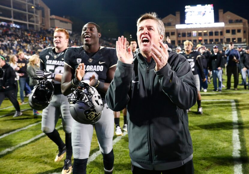 FILE - In this Nov. 19, 2016, file photo, Colorado head coach Mike MacIntyre sings the...