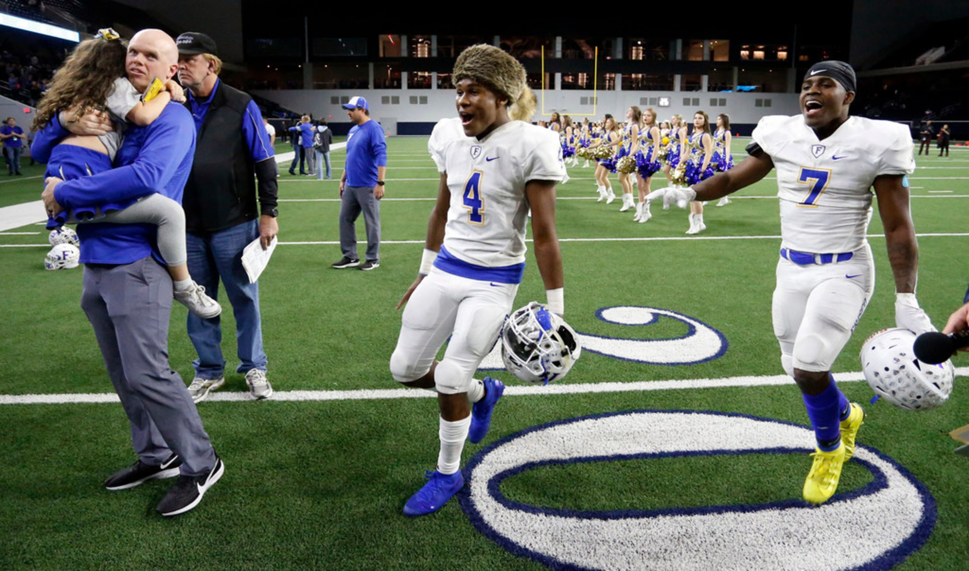 Frisco's Chase Lowery (4), clad in a raccoon skin cap, and Bryson Clemons (7) race around...