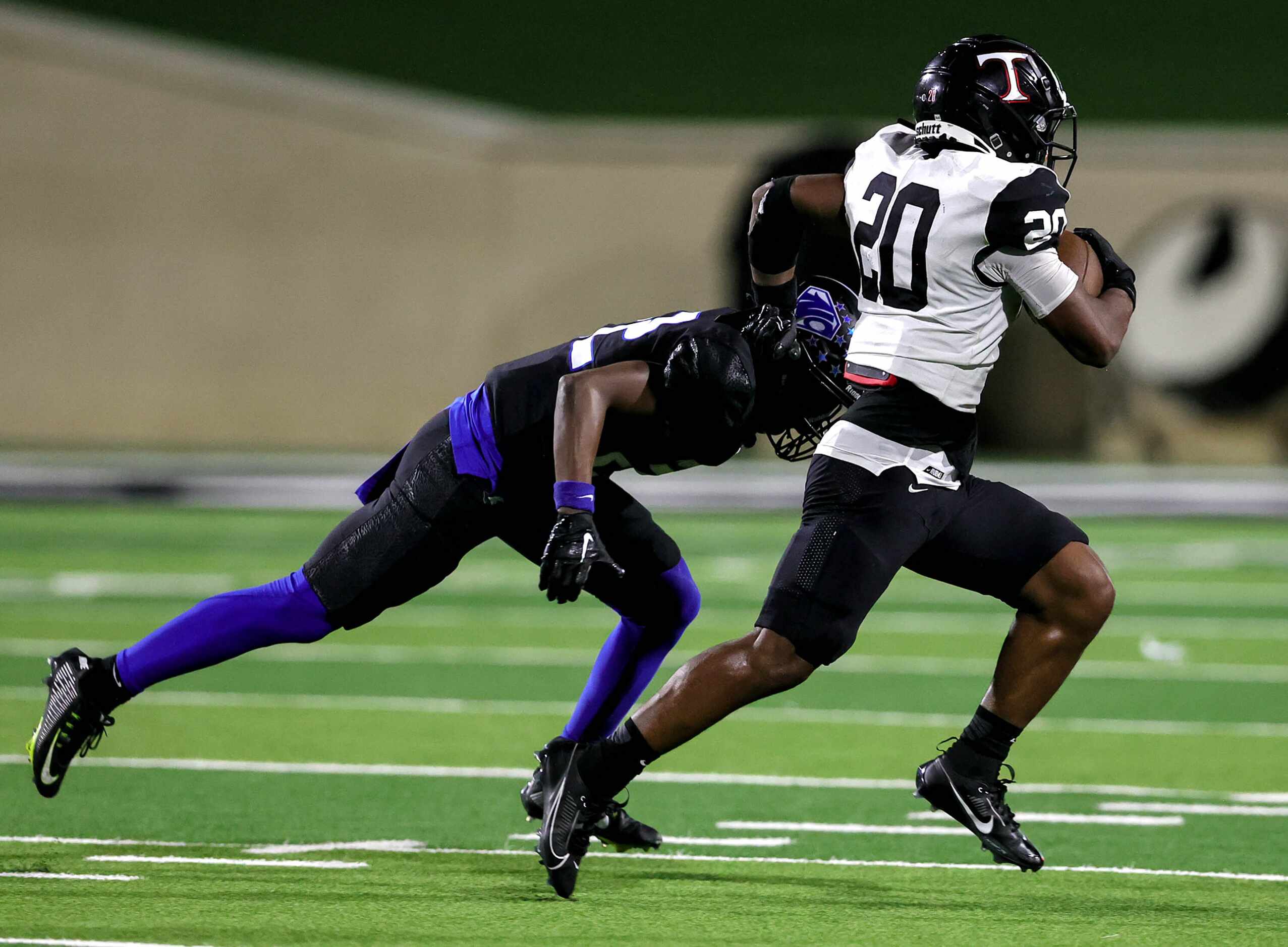 Euless Trinity running back Josh Bell (20) tries to race past North Crowley defensive back...