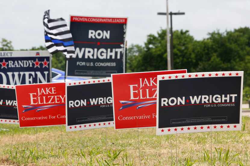 Competing signs for US Congressional candidates in District 6 stood outside the Ellis County...