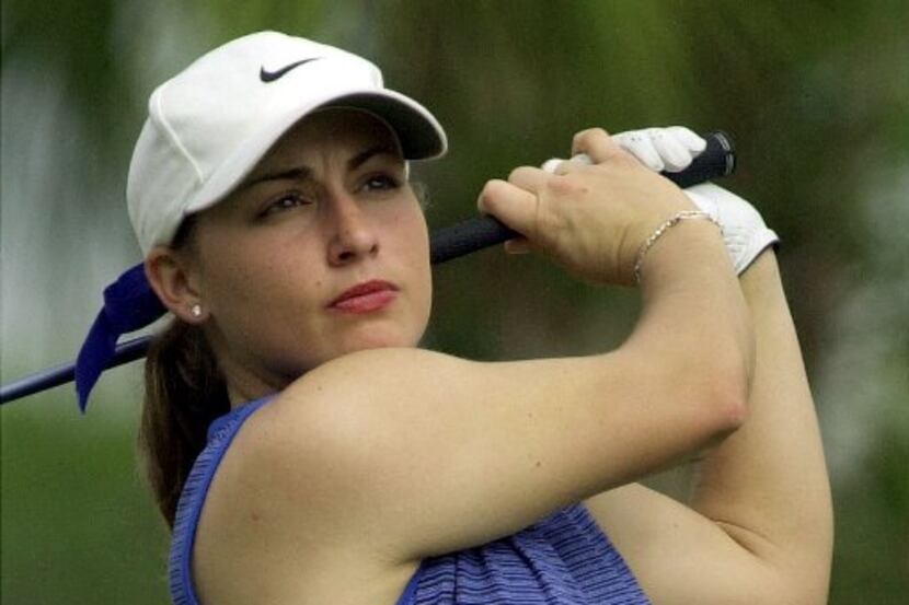 Kelli Kuehne, of Dallas, watches her drive off the second tee during the first round of the...