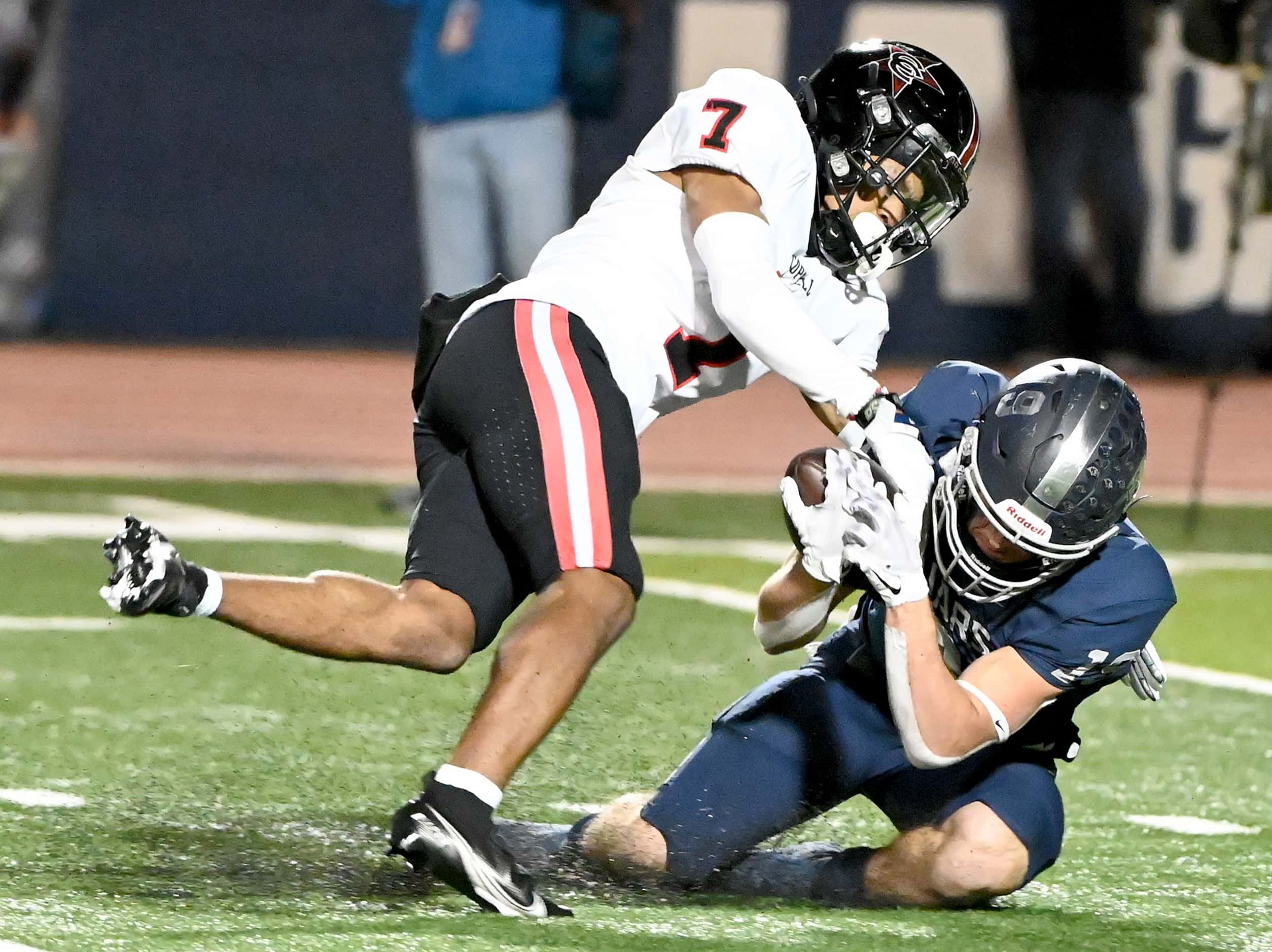 Flower Mound's Cade Edlein (19) is tackled by Coppell's Isaiah Nichols (7) in the first half...