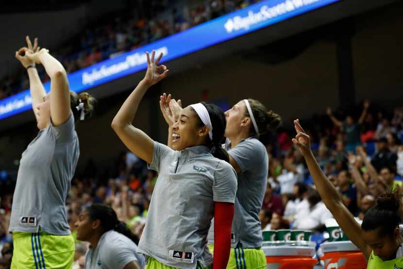 Dallas Wings guard Tiffany Bias (8) celebrates on the sideline along with teammates during a...