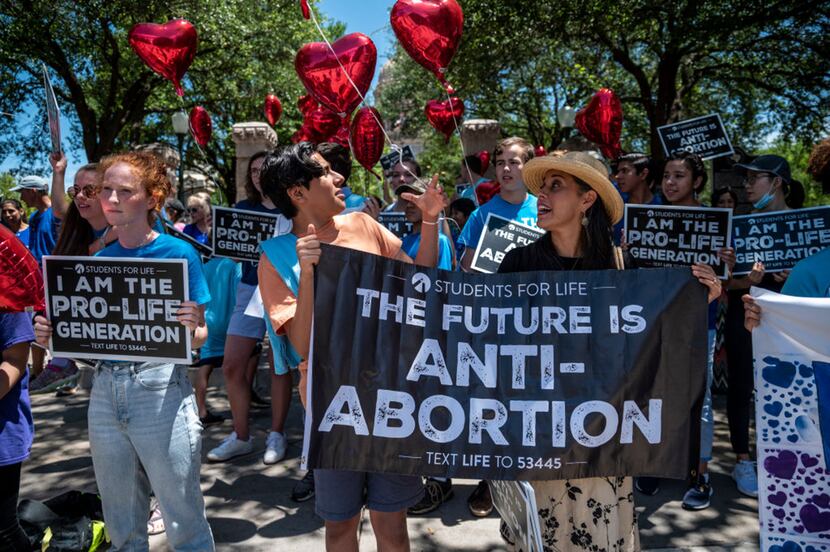 Pro-life protesters stand near the gate of the Texas Capitol on May 29, 2021.