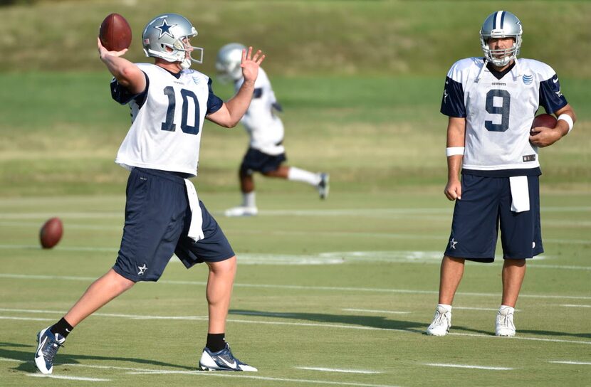 Dallas Cowboys quarterback Dustin Vaughan (10) throws as quarterback Tony Romo (9) watches,...