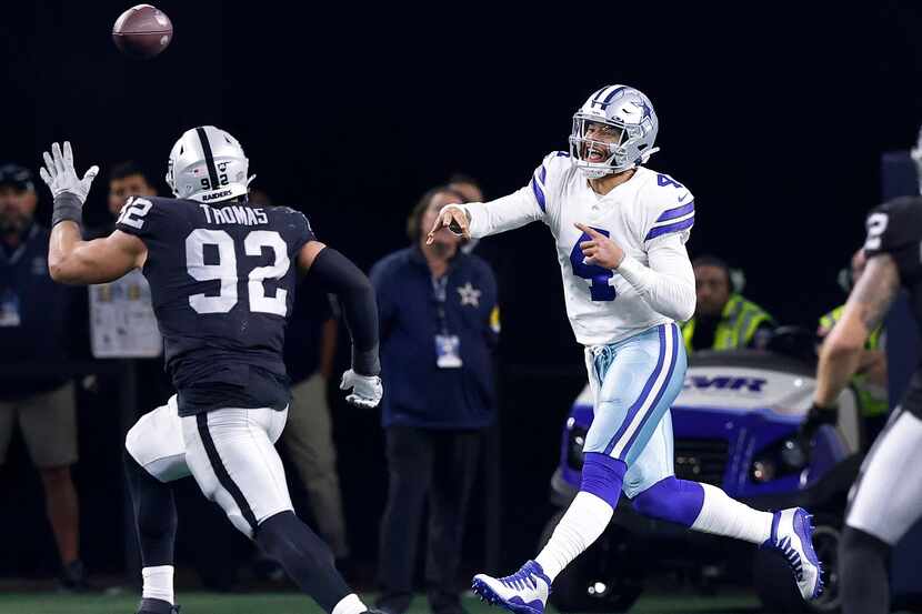 Dallas Cowboys quarterback Dak Prescott (4) throws a pass in overtime as he rolls out...