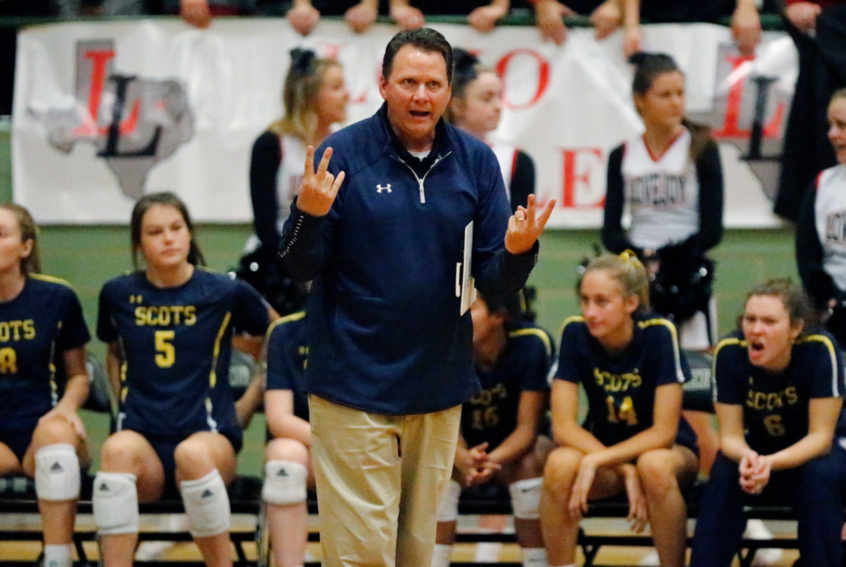 Highland Park High School head coach Michael Dearman tries to get a message to the ref in...